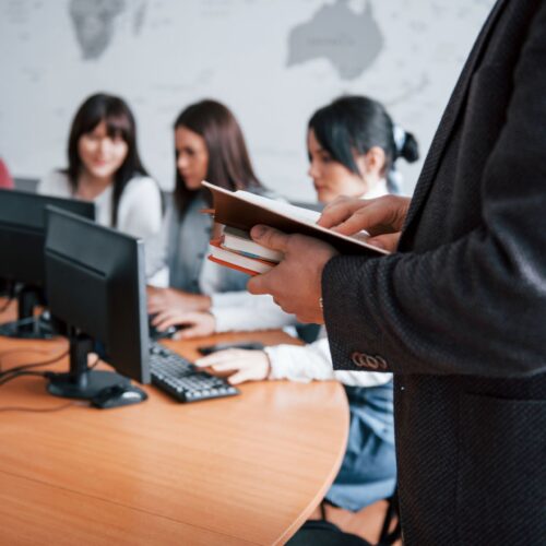 holding-notebooks-group-people-business-conference-modern-classroom-daytime